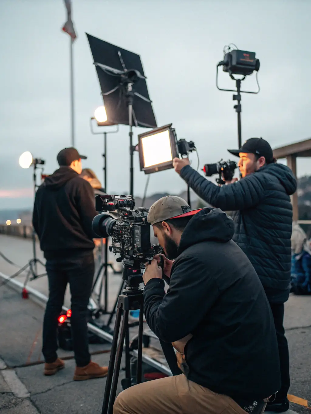 A behind-the-scenes shot of a film crew filming on location, with cameras and lighting equipment in action, illustrating the process of film production and the association's involvement in visual storytelling.